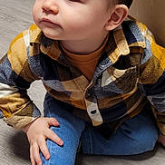 Marceau participe au concours pour gagner de l'argent avec cette photo : toddler, child, indoor, floor, clothing, jeans, shirt, plaid, shoe, footwear, hand, face, hair, curious, casual, young, person, seated, wood_floor, candid