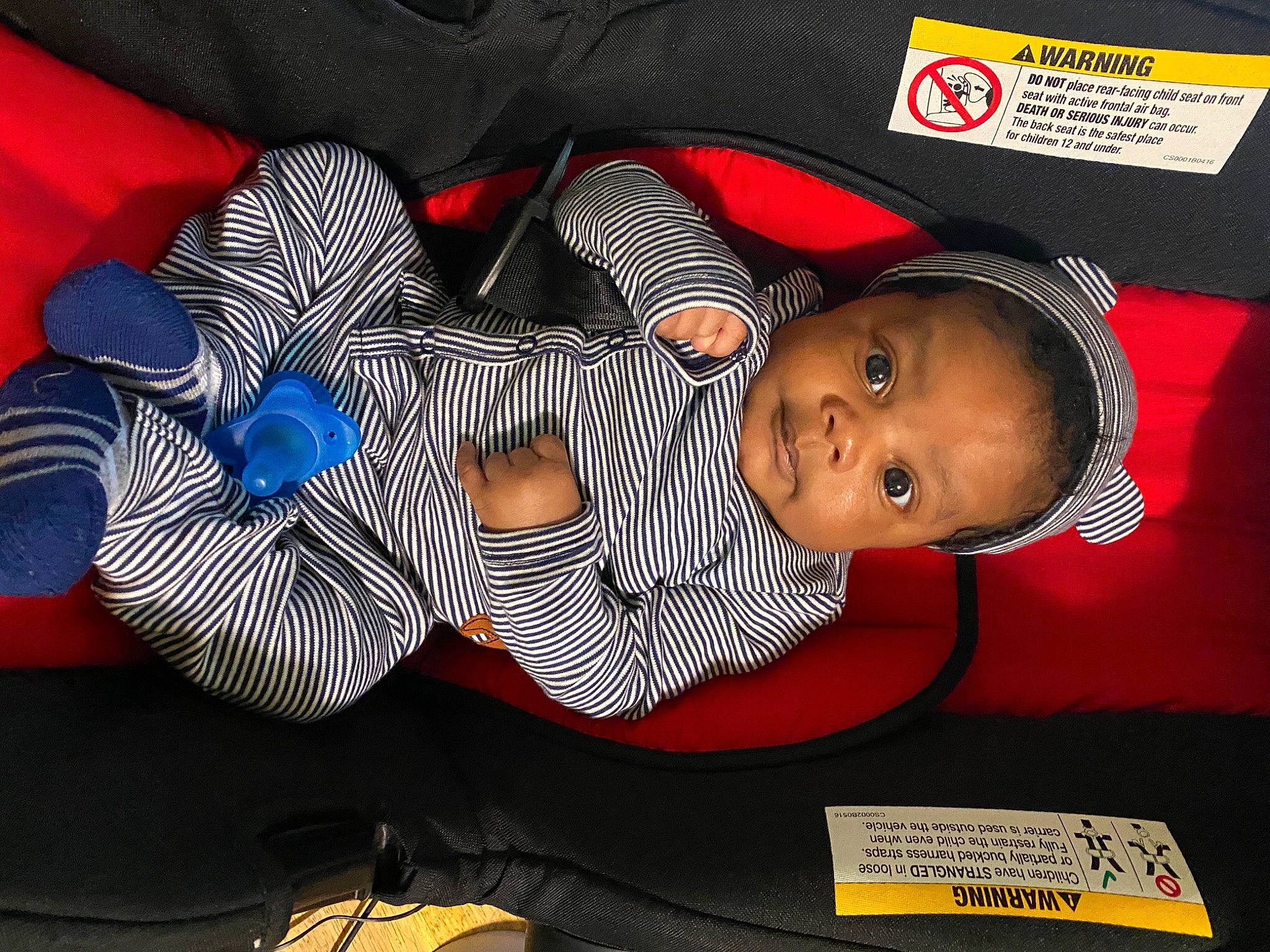 Dache is registered to the contest to win money with this photo: auto_part, automotive_wheel_system, baby, baby_products, baby_toddler_clothing, car_seat, carmine, child, comfort, electric_blue, font, hat, headgear, linens, pattern, person, product, room, t_shirt, toddler