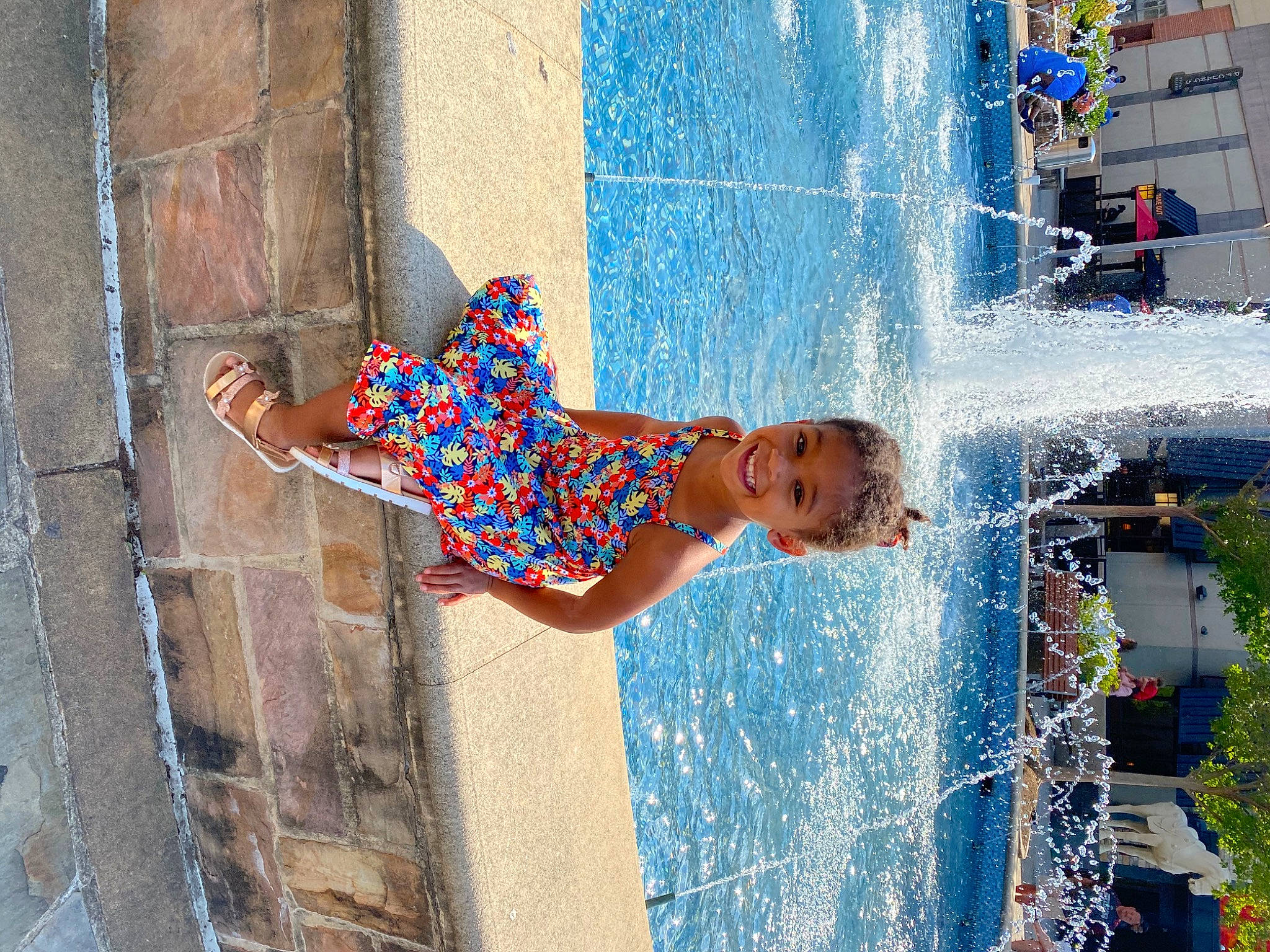 Kaylani joined the competition — help win amazing prizes! azure, body_of_water, child, city, daytime, electric_blue, fountain, fun, happy, human_settlement, joy, leisure, nonbuilding_structure, pattern, person, photograph, play, recreation, swimming_pool, toddler