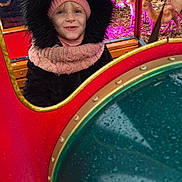 Shanna participe au concours pour gagner de l'argent avec cette photo : animal_figures, black, child, cold_weather, colorful, decorations, face, festive, holiday, hood, joyful, outdoor, pink, playful, portrait, reindeer, scarf, smiling, toy_train, winter_clothing