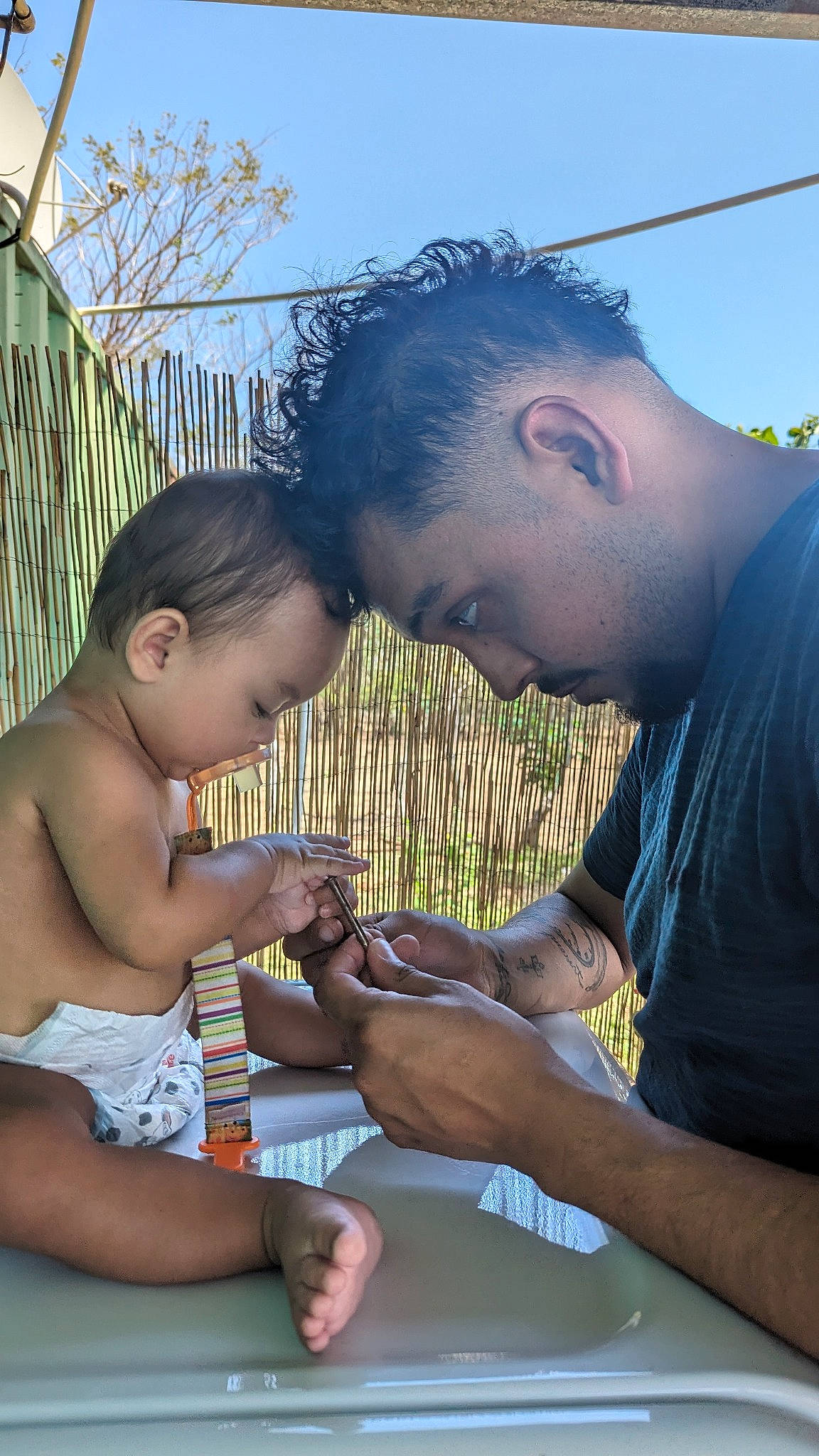 Alanna is registered to the contest to win money with this photo: adaptation, arm, child, fence, fun, gesture, grass, hairstyle, hand, happy, human, leisure, mouth, person, sharing, sky, summer, table, thumb, toddler