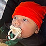 baby, infant, pacifier, orange_hat, blanket, car_seat, child, face, blue_eyes, warm_clothing, safety_harness, closeup, indoors, soft_texture, cute, wearing_hat, portrait, young_child, baby_boy, cozy