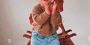 Dallas Grace is registered to the contest to win money with this photo: toddler, child, smile, clapping, headband, bow, sweater, denim_shorts, cowboy_boots, table, wooden_table, rocking_horse, wooden_floor, indoor, happy, person, playful, minimalist, home, furniture