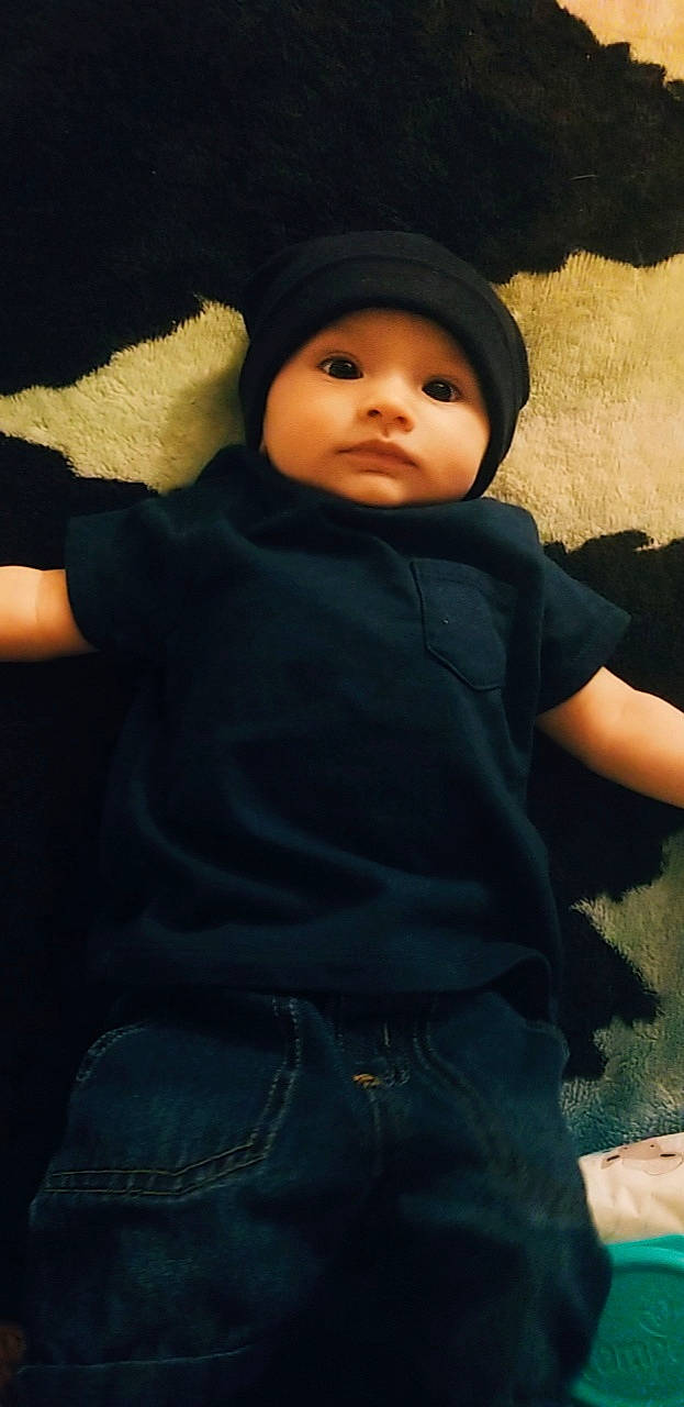 Eziah is registered to the contest to win money with this photo: baby, cheek, child, headgear, headwear, person, sitting, smile, toddler