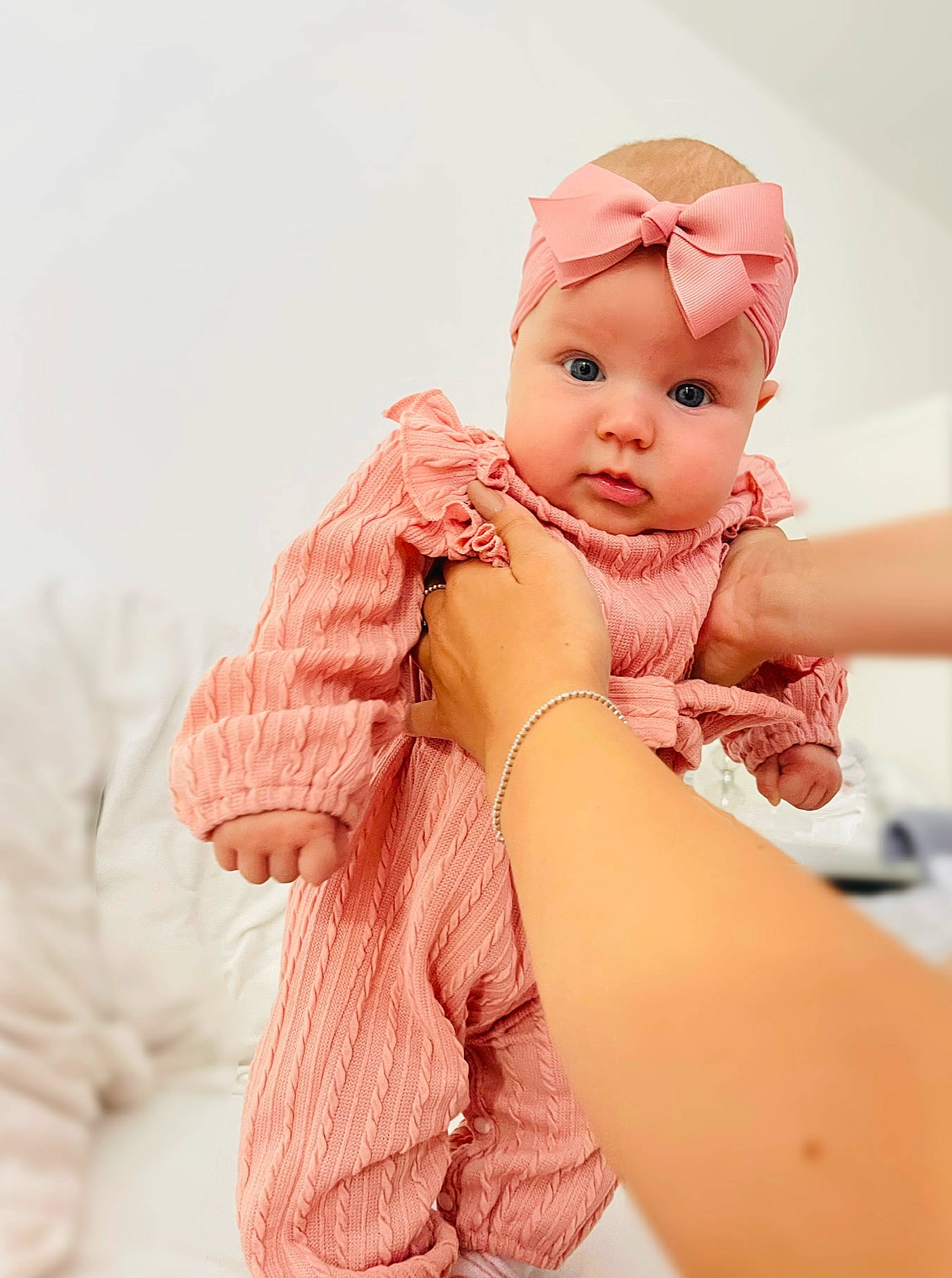 Bonnie is registered to the contest to win money with this photo: abdomen, baby, baby_sleeping, baby_toddler_clothing, cap, child, comfort, fashion_accessory, finger, gesture, happy, headwear, human_body, nail, person, pink, skin, sleeve, stomach, textile