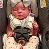baby, infant, sleeping, car_seat, harness, bow, headband, portrait, face, closed_eyes, baby_clothing, blanket, pink, white, vehicle_interior, safety, seat_belt, newborn, cute, photography