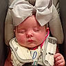 Nora joined the competition — help win amazing prizes! baby, infant, sleeping, bow, hair_bow, portrait, close_up, face, rosy_cheeks, closed_eyes, seated, baby_seat, safety_harness, car_seat, bib, clothing, hand, fist, indoor, photography
