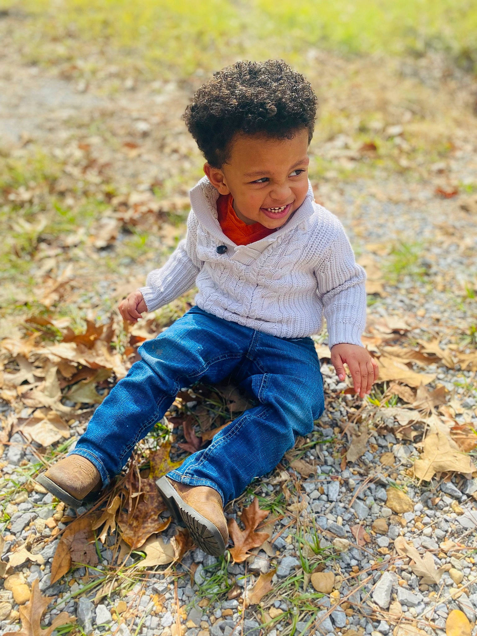Tre is registered to the contest to win money with this photo: adaptation, child, deciduous, denim, foot, grass, grass_family, hand, happy, jeans, joy, leaf, leisure, people_in_nature, person, plant, sitting, smile, soil, toddler