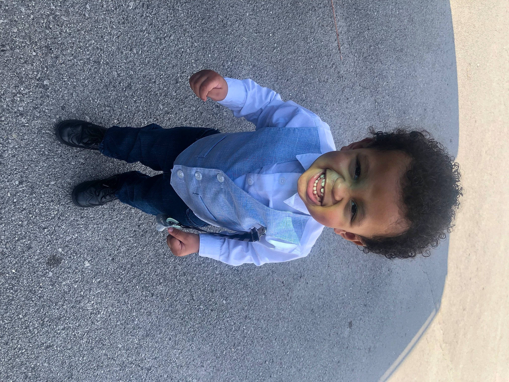 Tre is registered to the contest to win money with this photo: asphalt, concrete, denim, electric_blue, flooring, foot, fun, grey, human_leg, joy, pedestrian, person, road_surface, shadow, sidewalk, sitting, toddler, walking_shoe