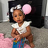 child, toddler, baby, portrait, sitting, indoors, carpet, pink_rug, balloon, piano, bow_headband, white_shirt, dress, book, colorful_book, numbers, curious, looking_at_camera, earrings, home
