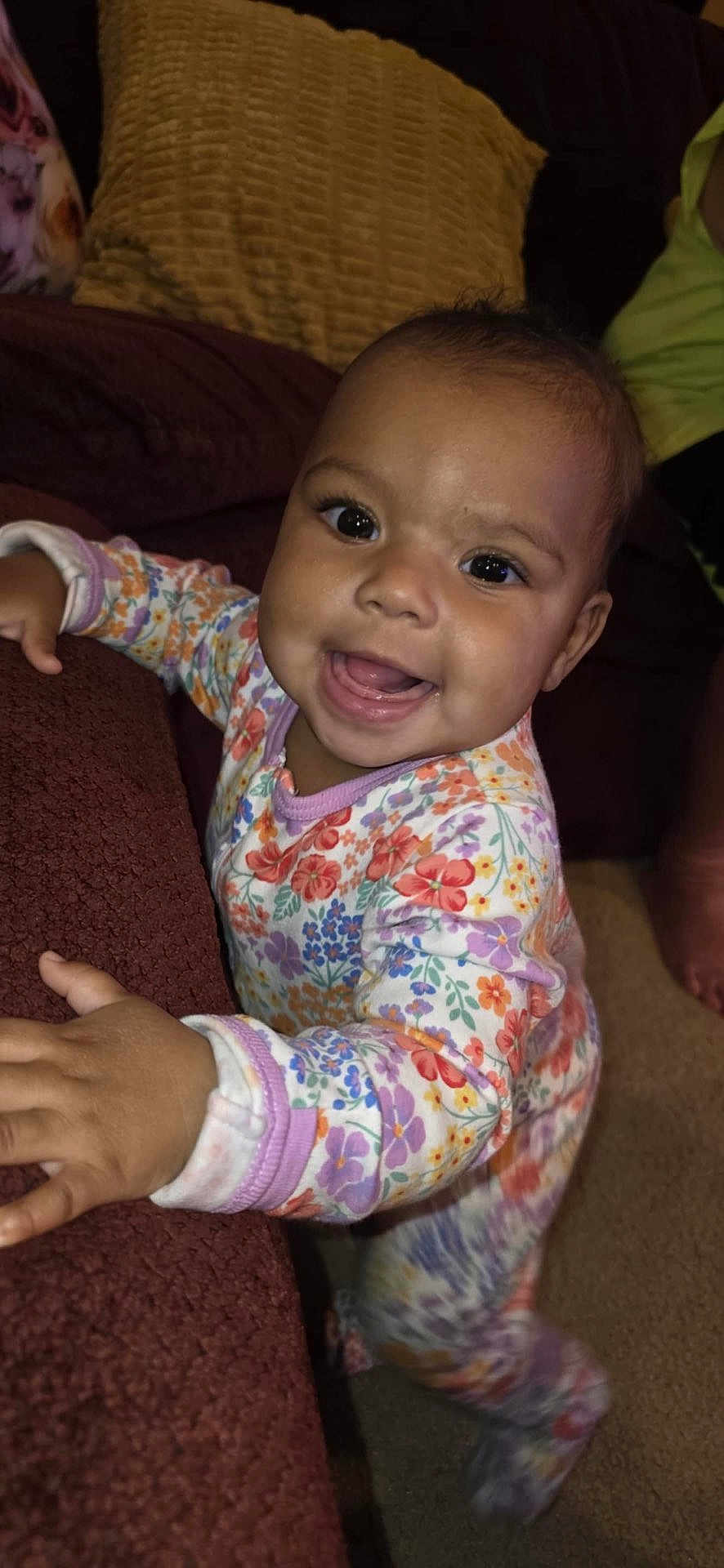 Desyah is registered to the contest to win money with this photo: baby, child, smiling, pajamas, floral, indoor, couch, fabric, hand, face, person, happy, infant, carpet, home, cute, young_child, clothing, portrait, bright