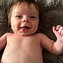 Riot is registered to the contest to win money with this photo: baby, smiling, tongue, hair, blanket, fuzzy, skin, lying_down, happy, infant, cute, expression, face, head, child, indoors, closeup, person, bare_chest, newborn