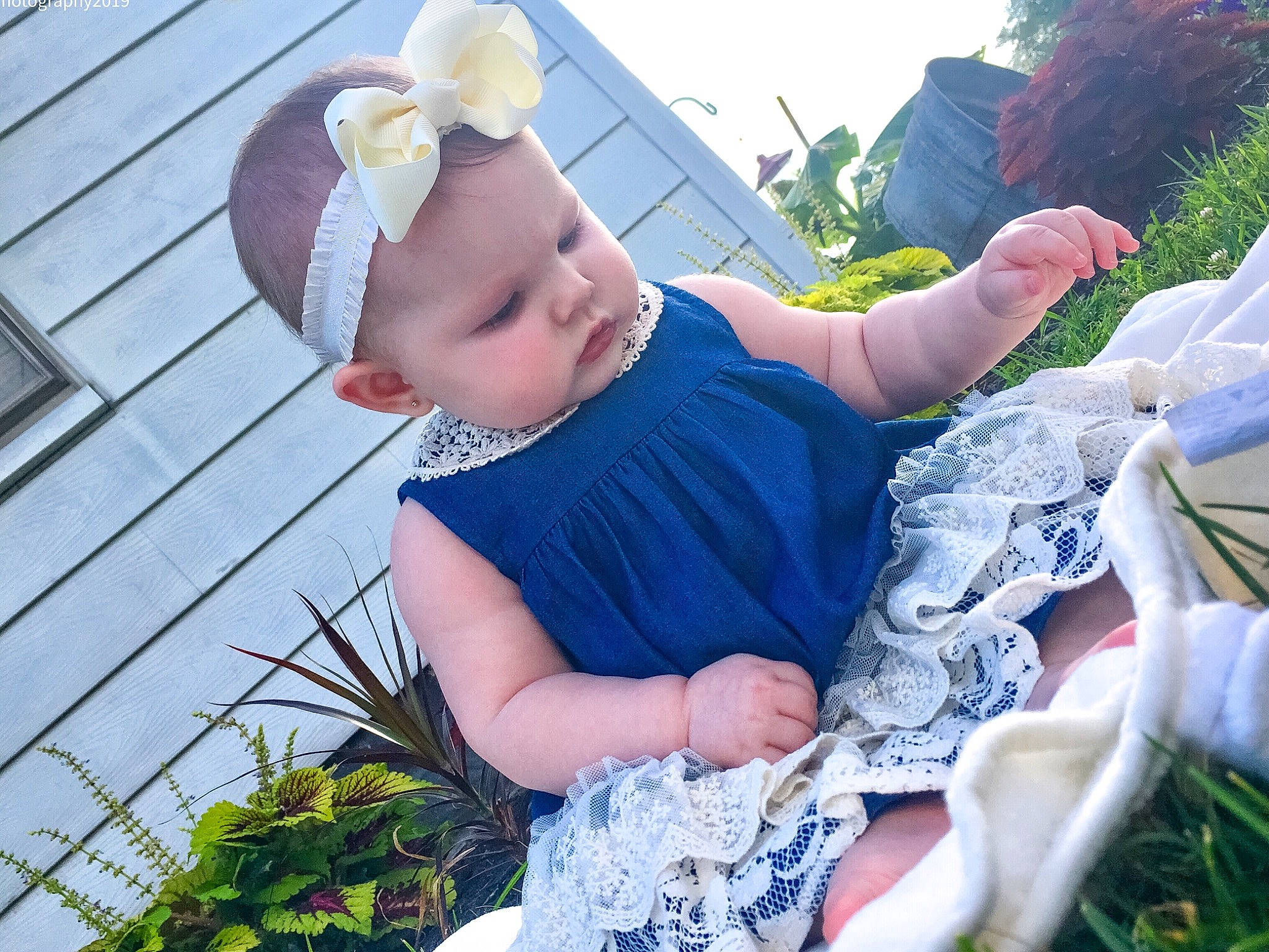 Kinsington is registered to the contest to win money with this photo: arm, baby, child, garden, grass, hand, headgear, lawn, leaf, leg, person, plant, sitting, summer, textile, toddler, vacation