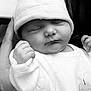 Naomie a rejoint le concours — aidez-le/la à gagner de superbes lots ! baby, newborn, sleeping, hat, onesie, infant, hand, face, closeup, monochrome, black_and_white, peaceful, cute, soft, cozy, portrait, child, person, resting, newborn_clothing