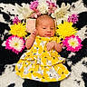 Alora joined the competition — help win amazing prizes! baby, infant, flower_crown, yellow_dress, floral_pattern, blanket, black_and_white, pink_flowers, yellow_flowers, white_flowers, lying_down, cute, newborn, soft_texture, portrait, child, peaceful, indoor, colorful, adorable