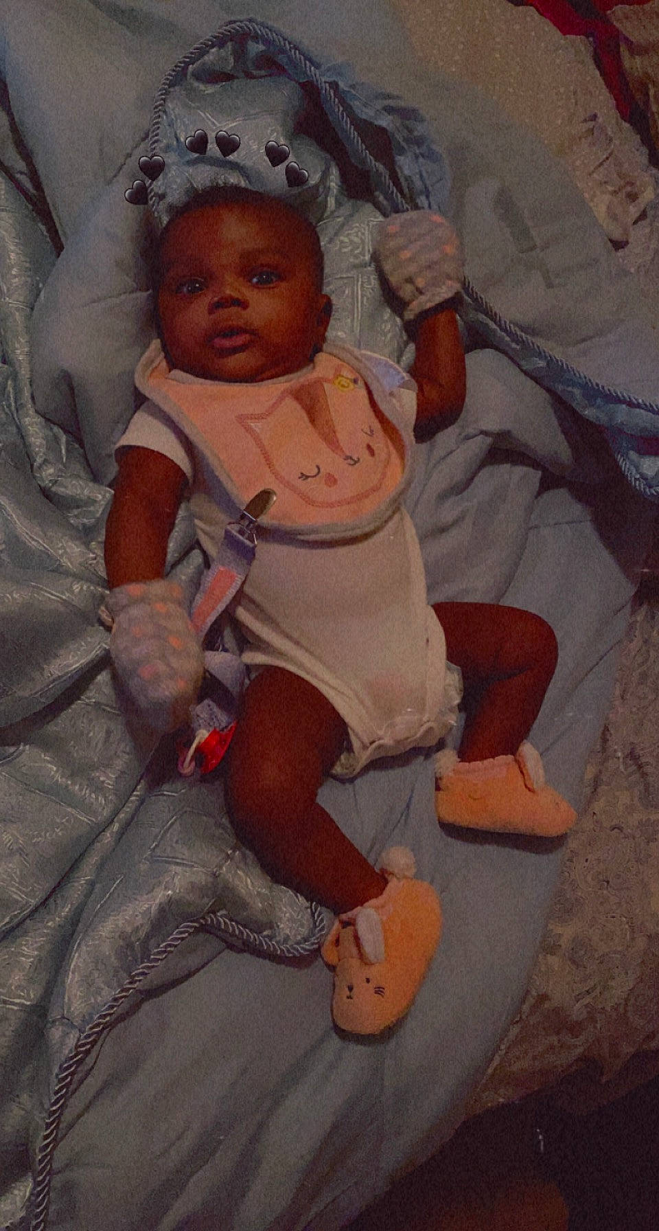 Imani is registered to the contest to win money with this photo: baby, baby_products, chest, child, comfort, foot, fun, hat, head, human_leg, knee, lap, linens, mouth, person, room, sandal, sitting, skin, thumb