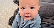 Noah joined the competition — help win amazing prizes! baby, bed, blanket, blue_clothing, child, curious, cute, face, feet, furniture, hands, head, home, indoors, infant, onesie, person, plush_toy, portrait, skin