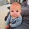 baby, bed, blanket, blue_clothing, child, curious, cute, face, feet, furniture, hands, head, home, indoors, infant, onesie, person, plush_toy, portrait, skin