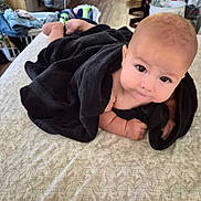 Noah joined the competition — help win amazing prizes! baby, basket, bedspread, blanket, doorway, eyes, face, floor, foot, furniture, hand, home, indoor, infant, laundry, pattern, person, skin, smile, towel