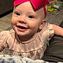 baby, child, smiling, bow, pink, dress, face, indoor, blanket, toy, happy, headband, person, infant, cute, cheerful, portrait, furniture, floor, home