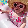 baby, child, sunglasses, hat, pool, inflatable, summer, outdoor, play, water, toy, grass, sunny, smile, pink, flower_shaped, clothing, swimsuit, cute, fun