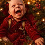baby, child, smiling, happy, red_clothing, christmas, holiday, festive, lights, greenery, bokeh, portrait, infant, cute, warm_lighting, celebration, nature, outdoor, seasonal, joyful