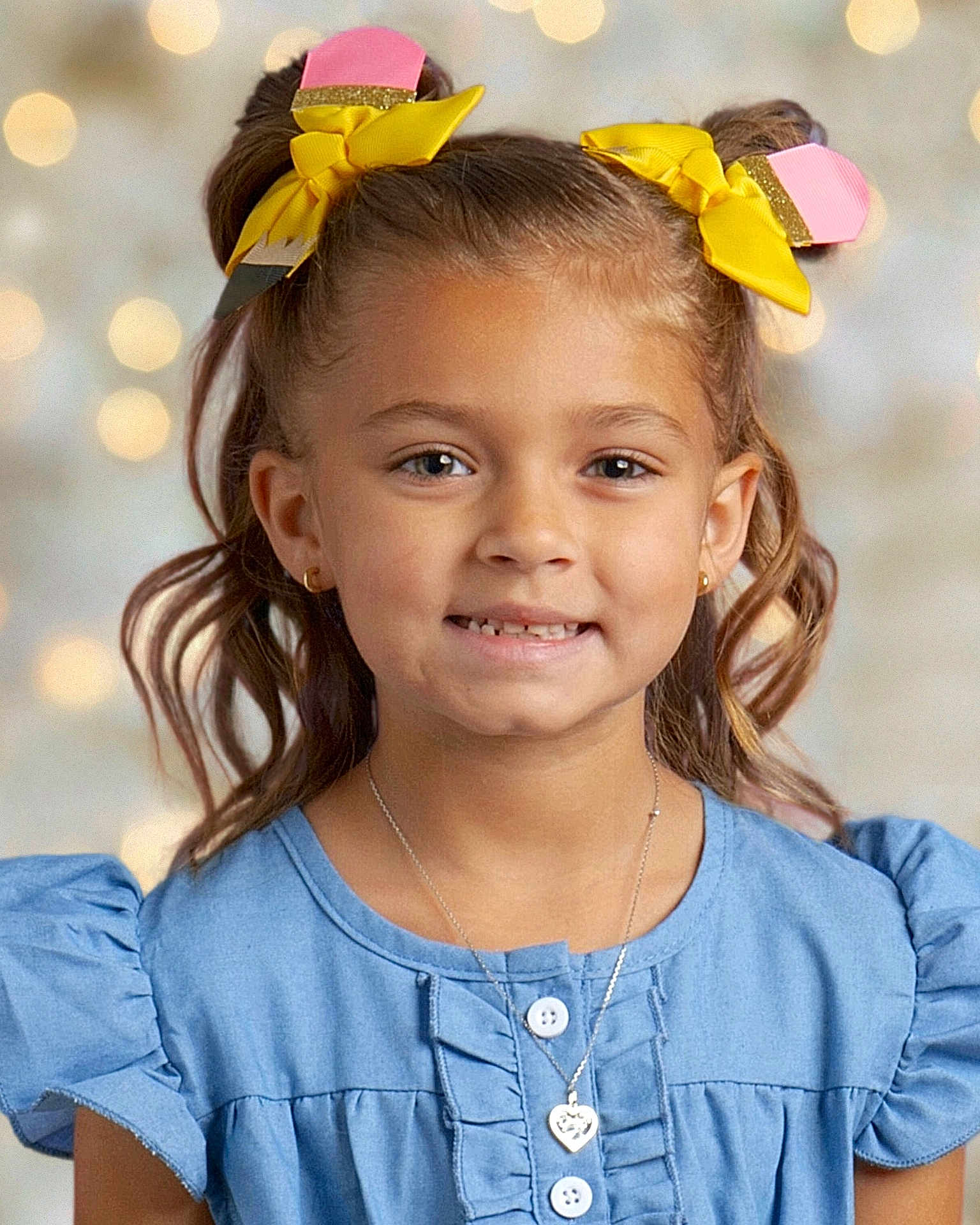 Delilah joined the competition — help win amazing prizes! child, girl, smiling, portrait, pigtails, yellow_bows, blue_dress, necklace, heart_pendant, earrings, curly_hair, happy, cute, face, young, fashion, studio_lighting, background_bokeh, innocence, childhood