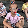 Delilah joined the competition — help win amazing prizes! child, girl, popsicle, glasses, face_paint, hair_tie, summer, outdoor, sidewalk, sitting, casual_clothing, friends, concrete, shoe, shorts, tshirt, playful, fun, daylight, tattoo