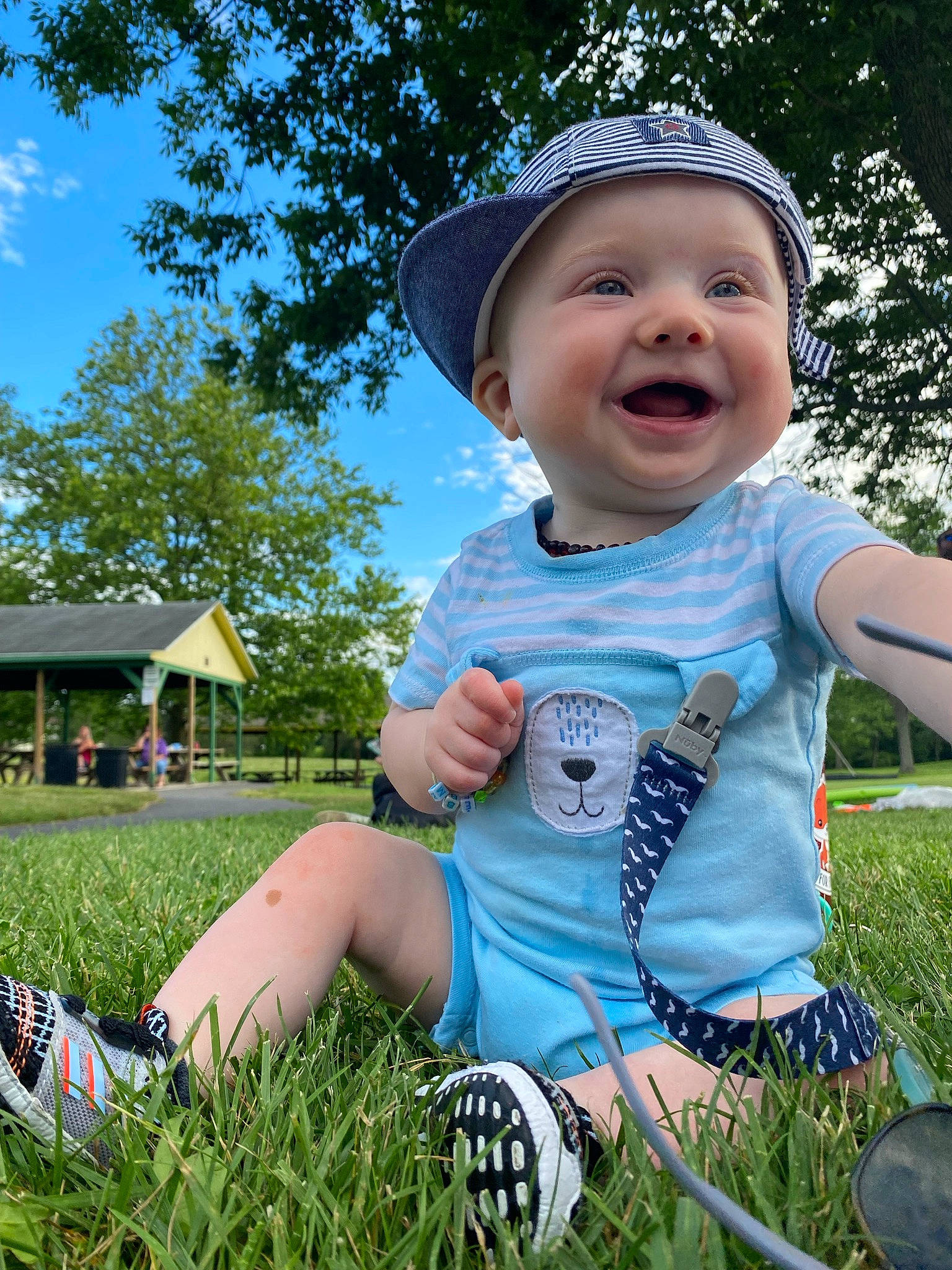 Emmitt is registered to the contest to win money with this photo: baby, baby_toddler_clothing, cap, cool, fun, grass, happy, hat, headwear, leisure, mammal, people_in_nature, person, plant, shorts, sky, smile, summer, sun_hat, toddler