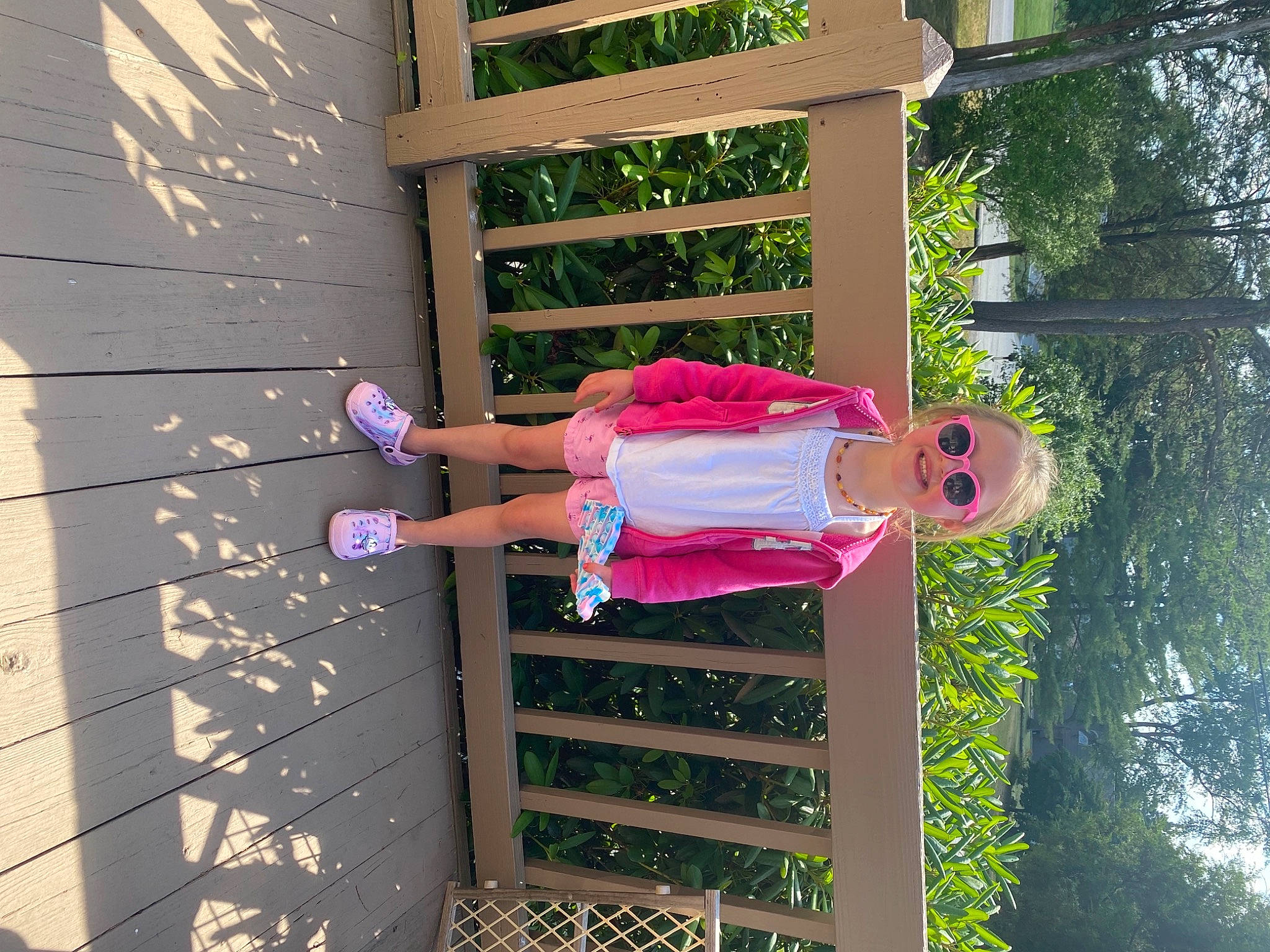 Remy is registered to the contest to win money with this photo: baby_toddler_clothing, design, fun, happy, house, human_leg, joy, leisure, line, magenta, people_in_nature, person, pink, plant, red, sandal, thigh, tints_and_shades, tree, waist