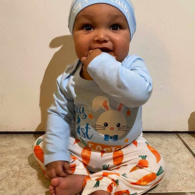 Jyaire is registered to the contest to win money with this photo: baby, babylaughing, biting, clothing, eating, face, food, happy, head, person, sitting, sleeve