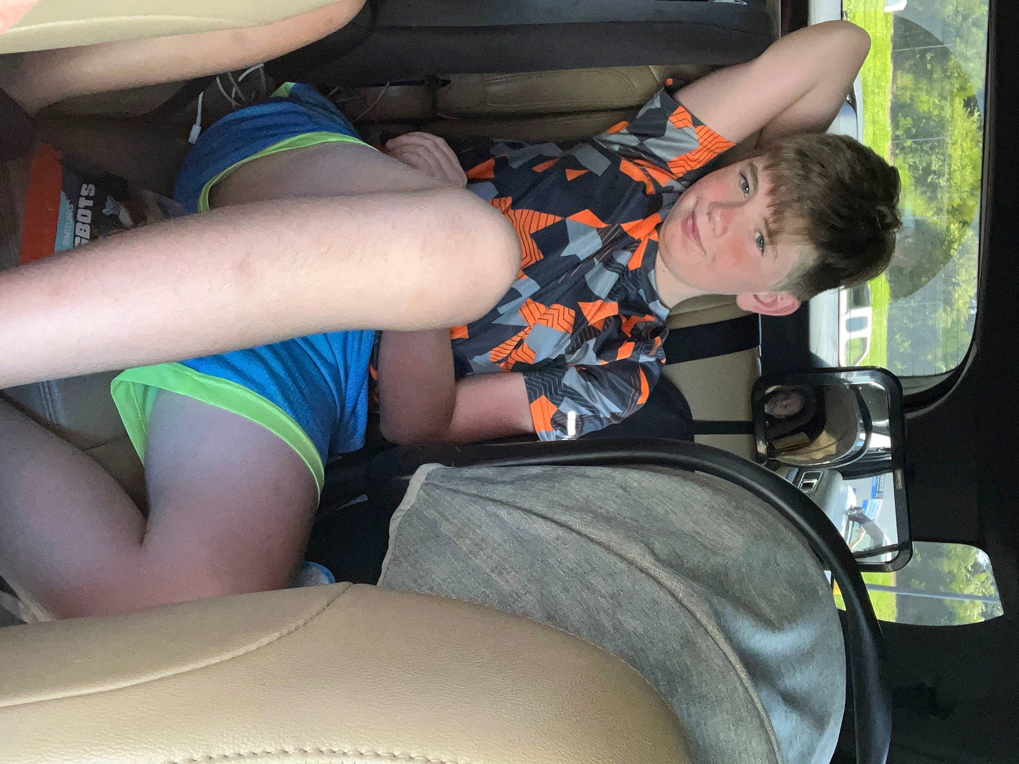 Jayden is registered to the contest to win money with this photo: automotive_design, automotive_exterior, automotive_tire, elbow, fun, human_leg, joint, joy, knee, lap, leg, motor_vehicle, person, plant, shorts, thigh, travel, tree, trunk, vehicle