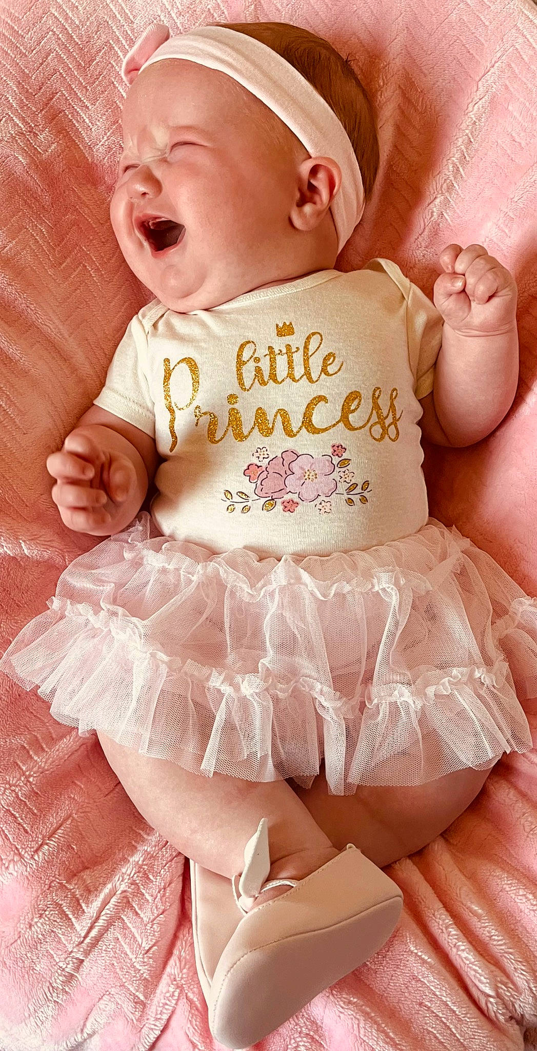 Esmae is registered to the contest to win money with this photo: arm, baby, baby_products, baby_sleeping, baby_toddler_clothing, child, clothing, comfort, finger, happy, human_body, pattern, peach, person, pink, ruffle, skin, sleeve, thigh, toddler