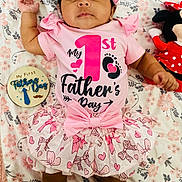 Meisha joined the competition — help win amazing prizes! baby, infant, child, pink_outfit, headband, plush_toy, minnie_mouse, floral_blanket, celebration, first_fathers_day, wooden_plaque, smiling, cute, tutu_skirt, lying_down, indoors, adorable, portrait, clothing, happy