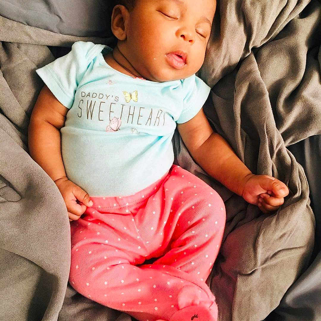 K'Lynn is registered to the contest to win money with this photo: baby, baby_in_car_seat, baby_products, baby_sleeping, baby_toddler_clothing, cheek, child, comfort, person, pink, product, sitting, skin, sleep, toddler