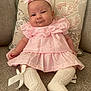 Dolcie joined the competition — help win amazing prizes! baby, bow, child, couch, cozy, cushion, cute, fabric, headband, home, indoors, infant, knitted_socks, person, pink_dress, portrait, seated, smile, soft_lighting, young_child