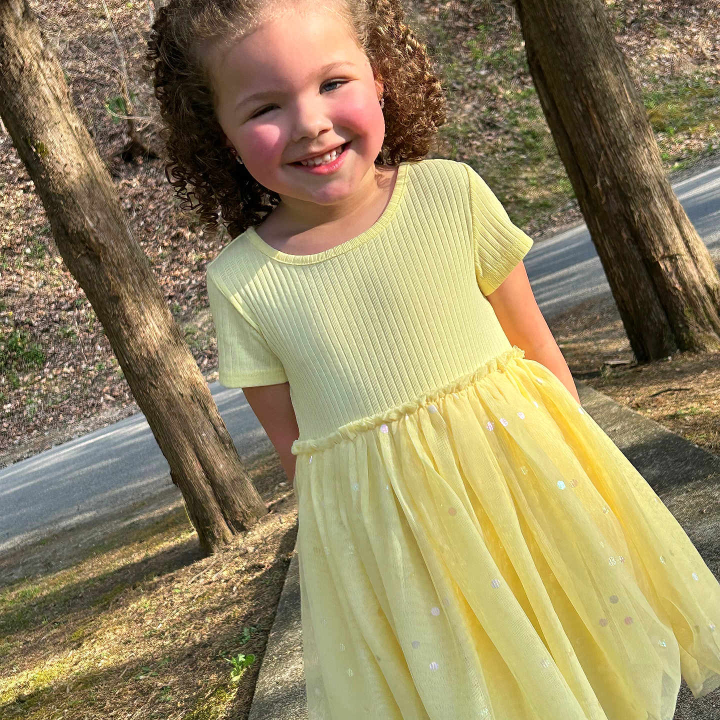 Rae Bates joined the competition — help win amazing prizes! casual, child, curly_hair, cute, daylight, fashion, girl, grass, happy, nature, outdoor, person, portrait, road, sidewalk, smiling, sunlight, trees, yellow_dress, young