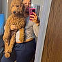 Bear is registered to the contest to win money with this photo: person, dog, goldendoodle, mirror, selfie, smartphone, phone_case, pink_case, curly_fur, sweatpants, long_sleeve_shirt, bracelet, bedroom, carpet, mirror_reflection, stickers, heart_graphic, sparkles_graphic, holding, home_interior