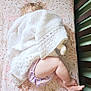 baby, blanket, child, crib, curly_hair, doll, floral_sheet, indoors, infant, knitted_blanket, leg, nursery, patterned_sheet, peaceful, plush_toy, sleeping, soft_toy, toy, wooden_crib, young_child