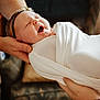 Charlotte is registered to the contest to win money with this photo: baby, swaddled, blanket, hands, yawning, infant, headband, sleepy, soft_light, indoor, person, closeup, newborn, care, comfort, portrait, family, tenderness, rest, cute