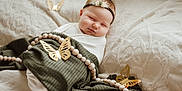 Charlotte is registered to the contest to win money with this photo: baby, sleeping, blanket, beads, butterfly, headband, face, child, infant, resting, soft_light, decor, texture, white, green, cute, peaceful, portrait, indoors, cozy