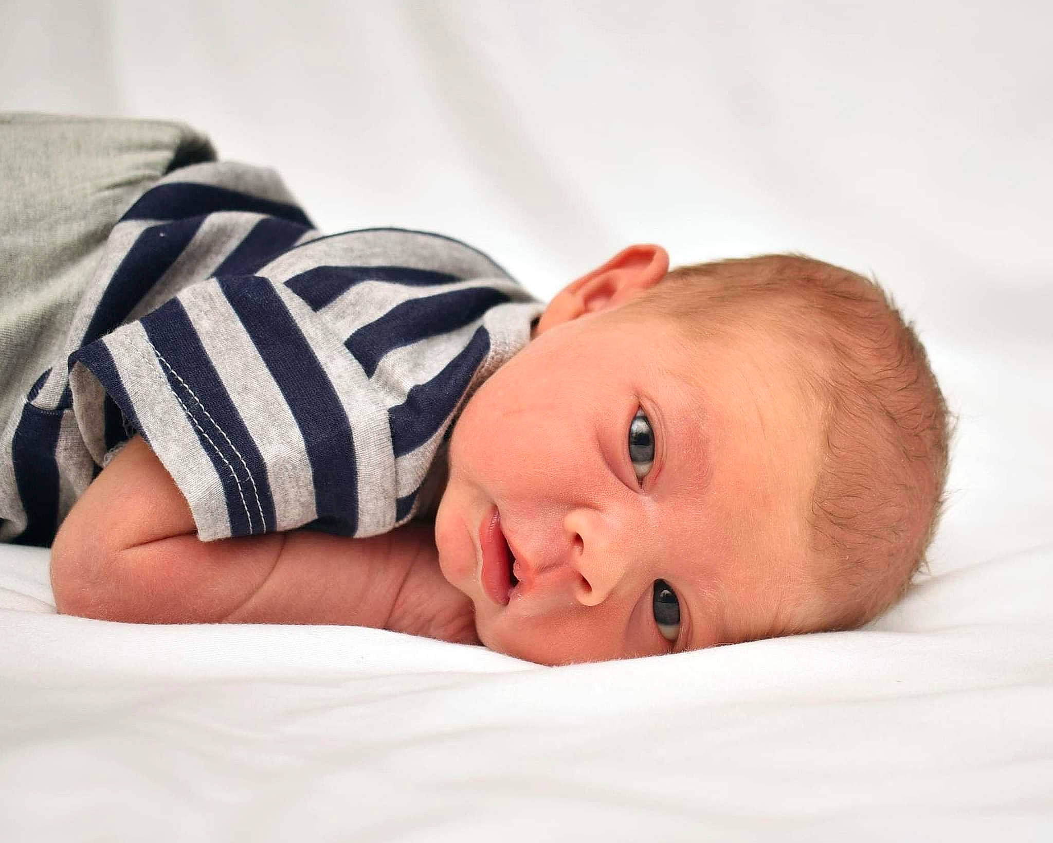 Anakin is registered to the contest to win money with this photo: arm, baby, baby_products, baby_sleeping, baby_toddler_clothing, bedding, bedtime, cheek, child, comfort, eye, fur, happy, linens, pattern, person, portrait_photography, room, sitting, sleeve