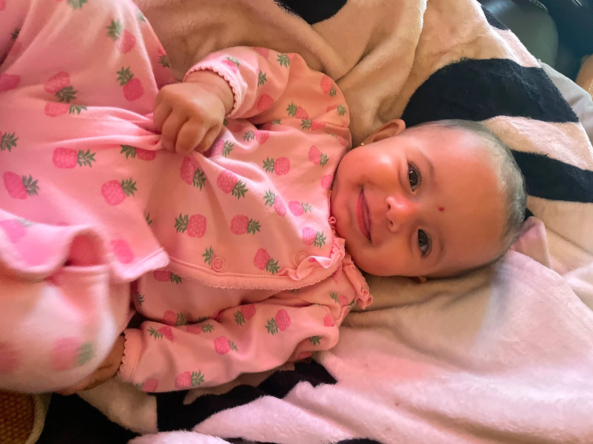 Amaya is registered to the contest to win money with this photo: abdomen, baby, baby_products, baby_toddler_clothing, cheek, child, comfort, flesh, joy, linens, mouth, nail, nightwear, nose, pattern, peach, person, pink, room, skin