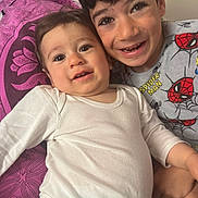 Daniel participe au concours pour gagner de l'argent avec cette photo : baby, boy, candid, child, closeup, cushion, cute, face, happy, indoor, person, playful, portrait, purple, sibling, smile, spiderman, toddler, white_clothing, young