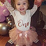 Julie is registered to the contest to win money with this photo: toddler, child, birthday, party, balloons, tutu, pink, white_shirt, celebration, happy, smiling, holding_hands, floor, confetti, indoor, adult_hands, shoes, person, festive, cute