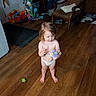 Willow is registered to the contest to win money with this photo: toddler, child, indoor, wooden_floor, toys, flowers, barefoot, living_room, armchair, diaper, curly_hair, young_child, playing, home, furniture, flooring, person, cute, small_bouquet, colorful_toys