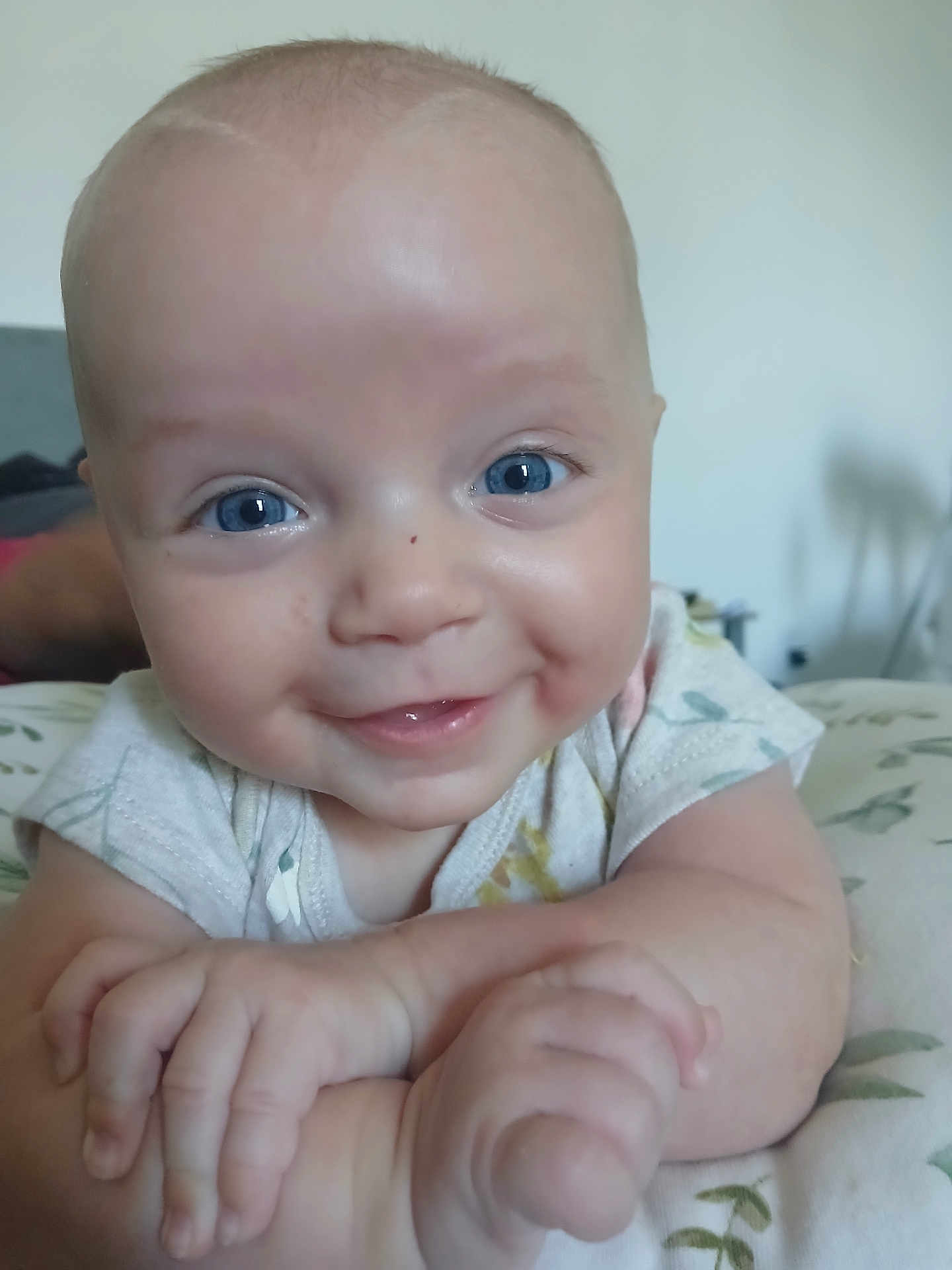 Ashlyn joined the competition — help win amazing prizes! baby, smiling, blue_eyes, close_up, infant, hands, face, cute, happy, child, skin, portrait, young, light, indoor, expression, person, resting, clothing, soft_background