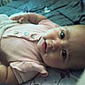 Dahlia joined the competition — help win amazing prizes! baby, infant, child, pink_clothing, buttons, bed, blanket, lying_down, face, eyes, hand, skin, cute, portrait, indoors, person, young_child, sleepwear, soft_lighting, closeup