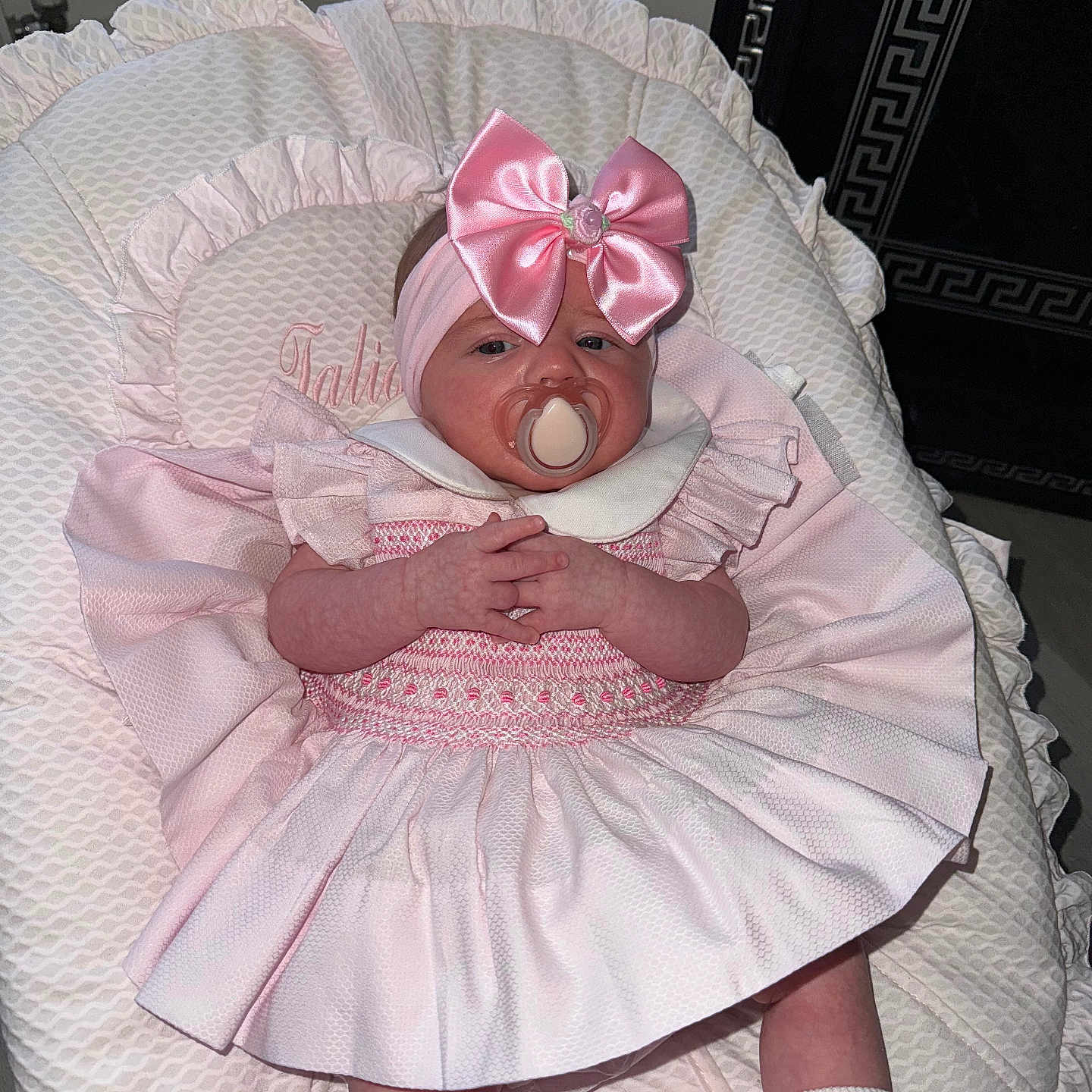 Talia-Louise is registered to the contest to win money with this photo: baby, baby_lounger, bow, child, clothing, cushion, cute, face, hand, headband, indoor, infant, laying_down, newborn, pacifier, person, pink_dress, shoe, sock, soft_texture