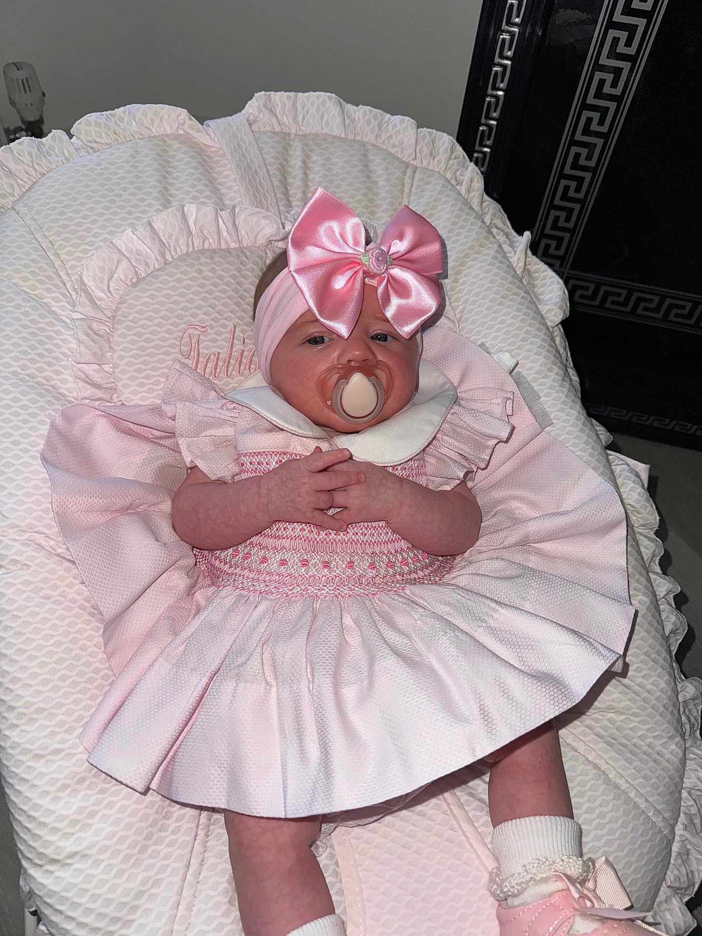 Talia-Louise is registered to the contest to win money with this photo: baby, infant, pacifier, pink_dress, headband, bow, cushion, baby_lounger, clothing, sock, shoe, hand, face, person, indoor, newborn, cute, child, laying_down, soft_texture